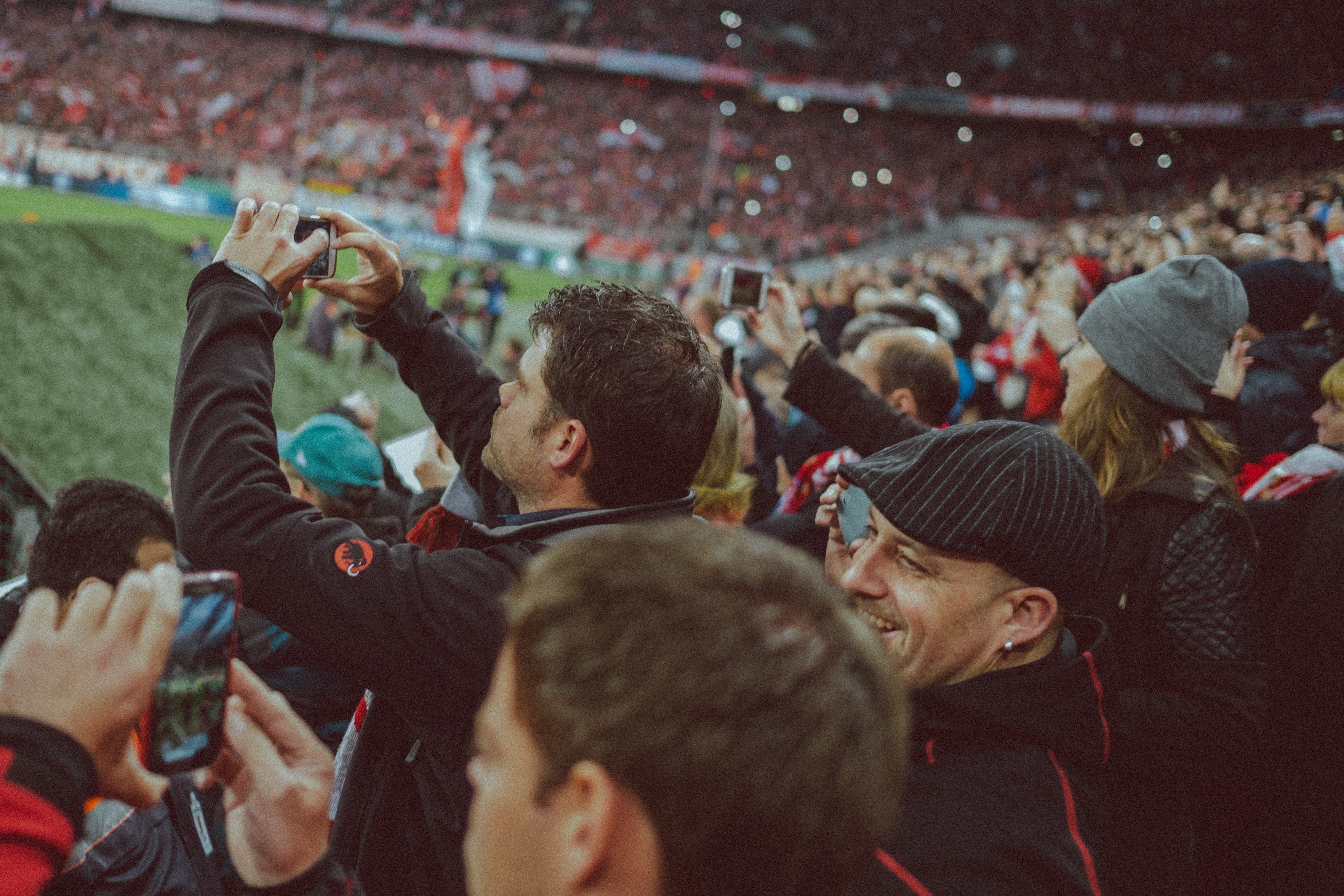Football fans filming from the stands